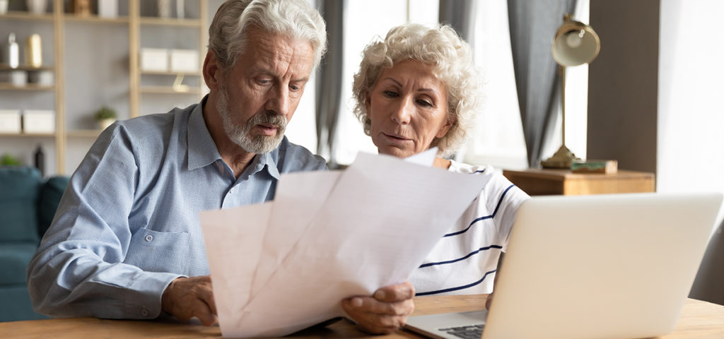 A senior couple reading some documents