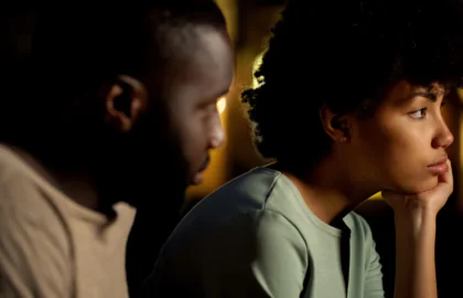 A couple sitting side by side, silent after a hard conversation.